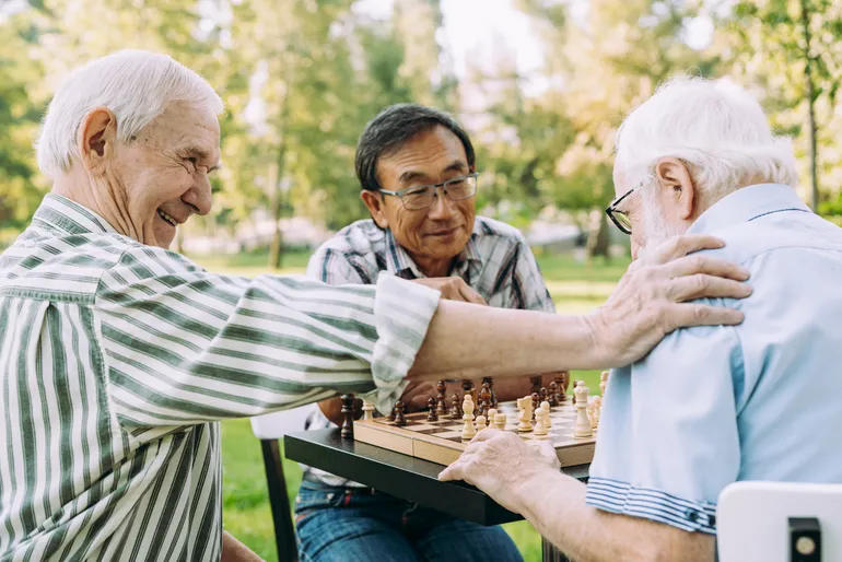 residents playing chess outdoors