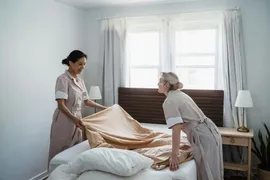 housekeeping staff making up a resident apartment