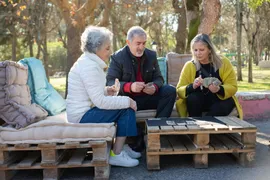 residents and a family member visiting outdoors